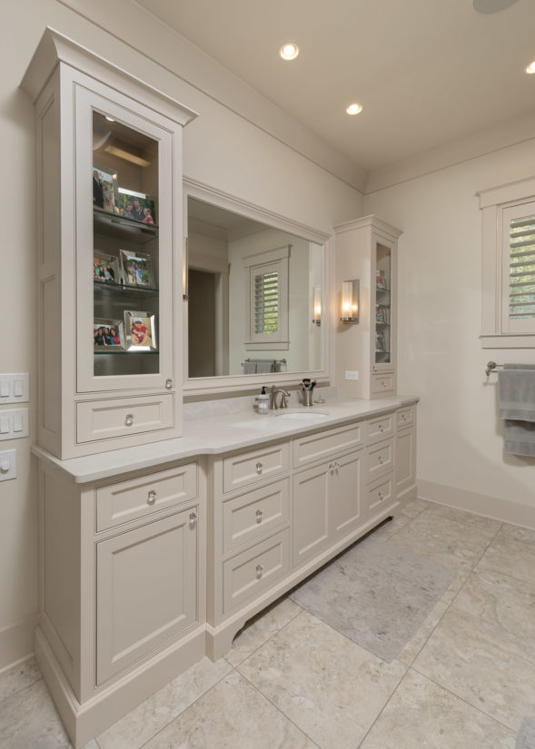 Beige painted master bathroom with glass panel doors and recessed panels