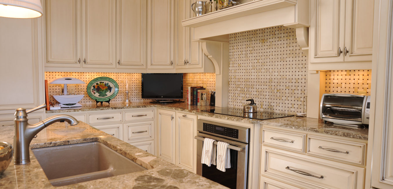 Kitchen with partial overlay cabinetry and recessed panel door fronts