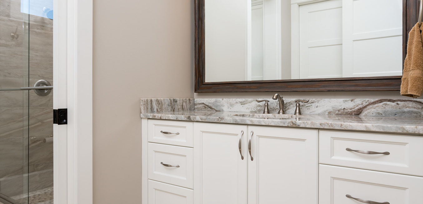 White full overlay bathroom vanity with recessed panel door fronts