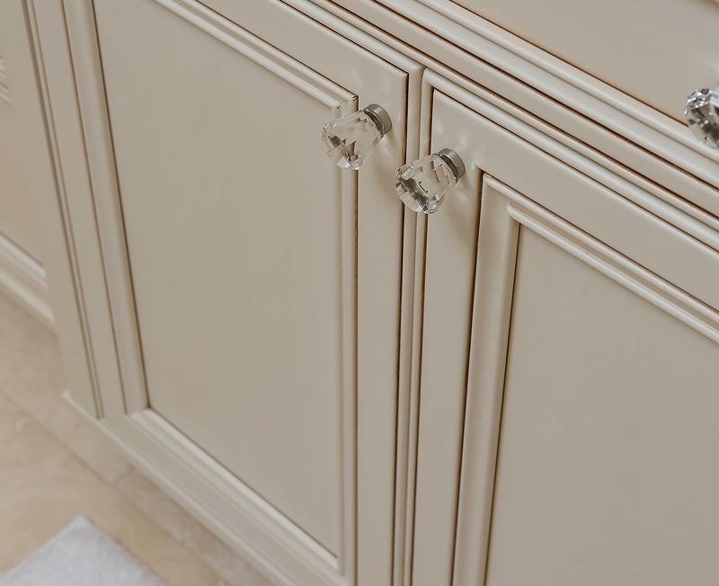 Decorative recessed panel doors with crystal knobs on a full overlay vanity