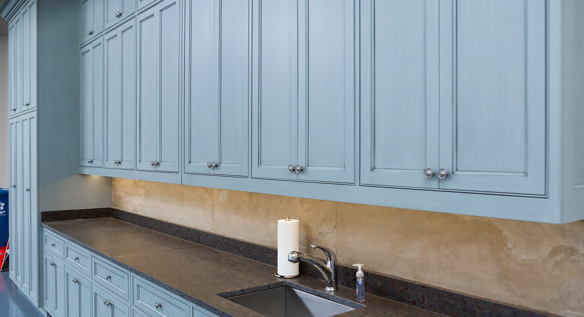 Blue garage storage cabinets with beaded inset cabinetry and recessed panel door and drawer fronts