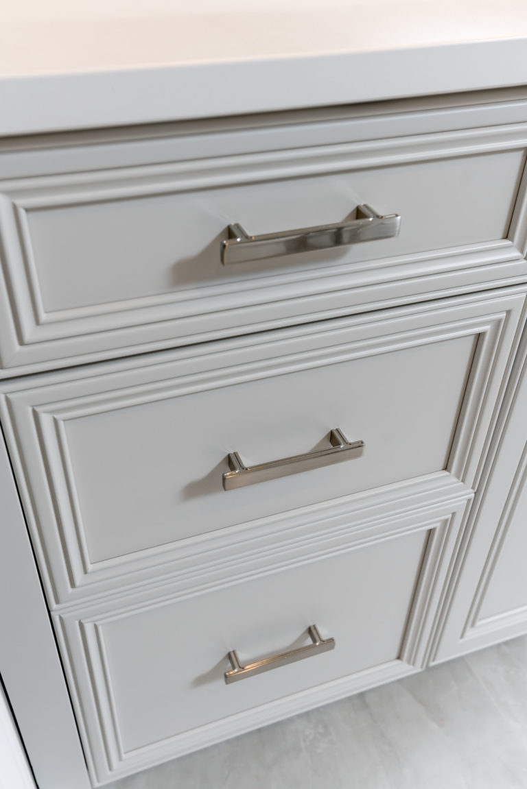 Jeffery Alexander Anwick Pull in polished chrome on inset bathroom vanity drawers with recessed panels