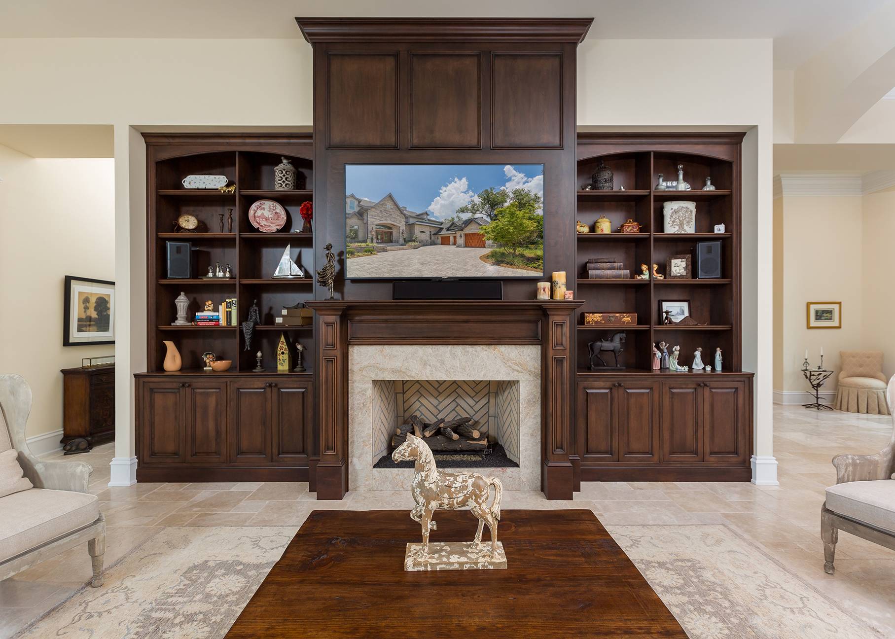 This dark stained entertainment center has shelving on the sides and lower raised panel doors for storage